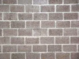Mur en briques grises avec joints blancs, texture uniforme, idéal pour des projets de construction ou de design intérieur.
